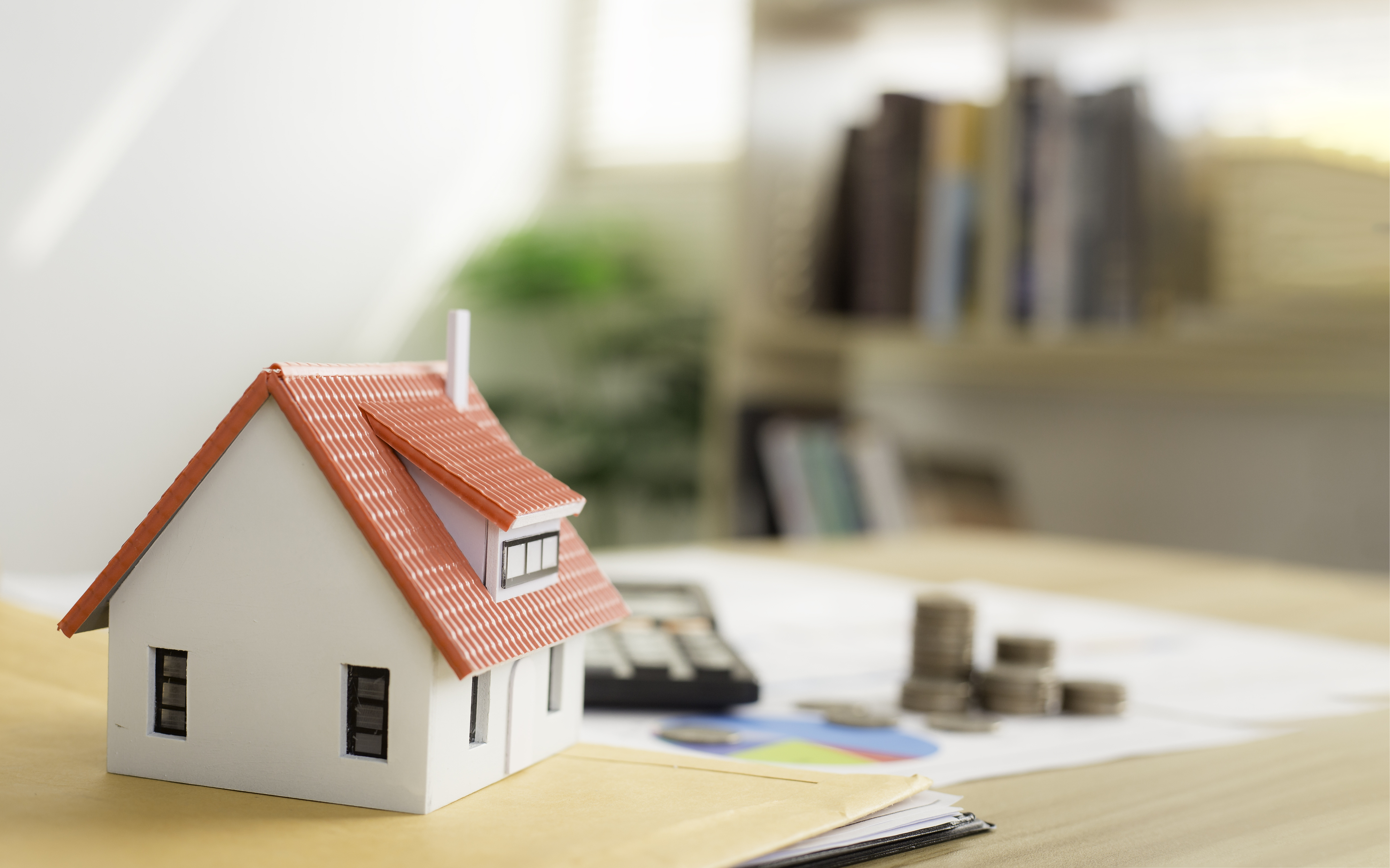 a%20house%20figurines%20and%20some%20coins%20on%20a%20desk a%20house%20figurines%20and%20some%20coins%20on%20a%20desk